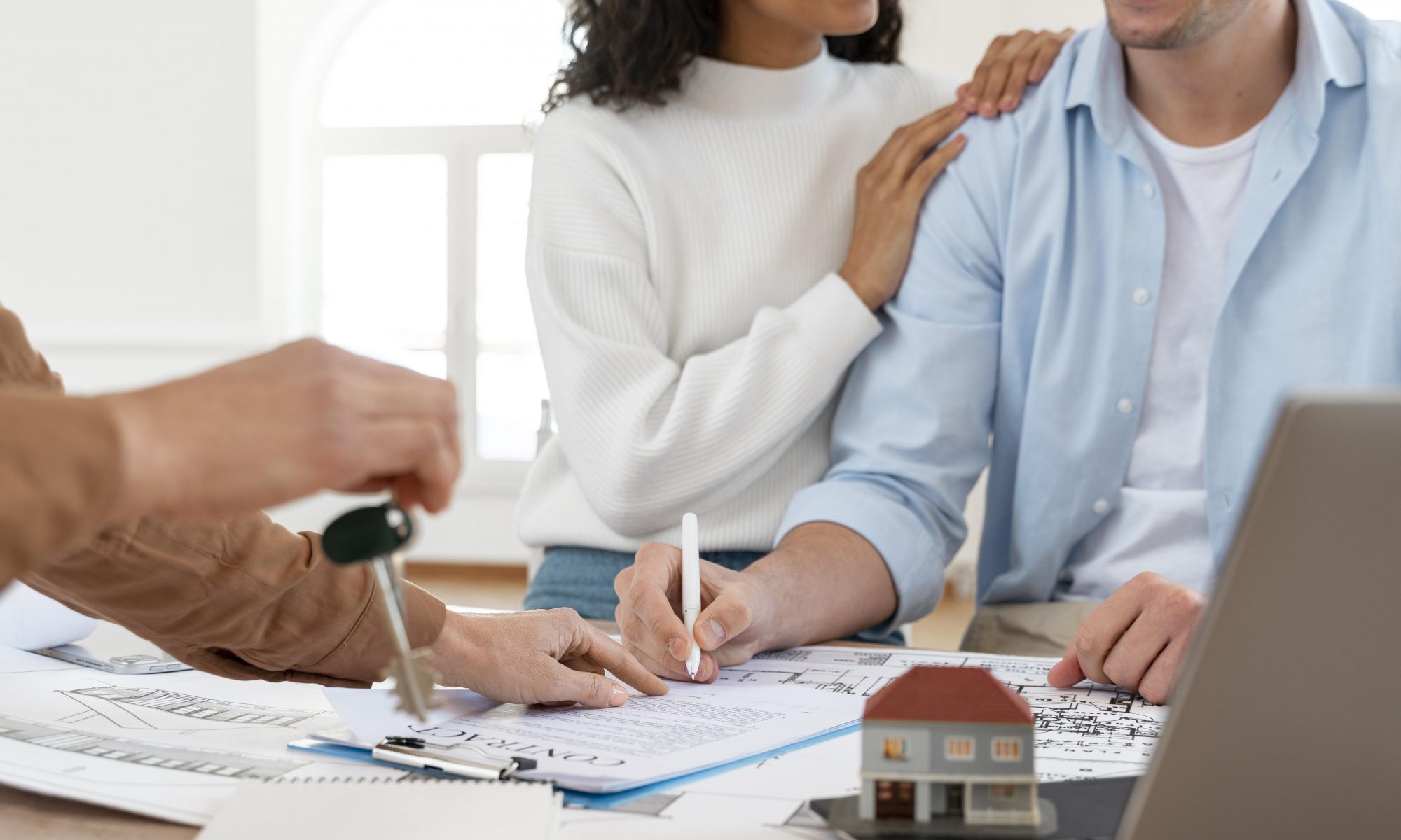 Happy couple signing contact for new home