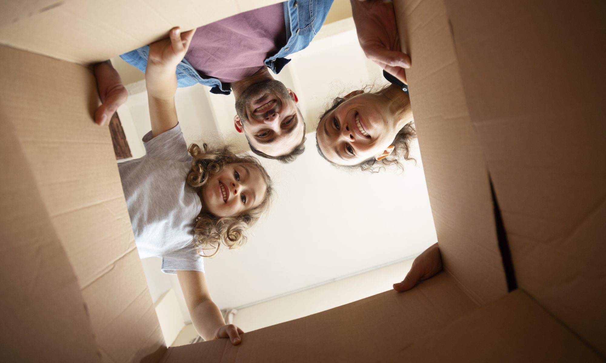 A family look into a box after moving home