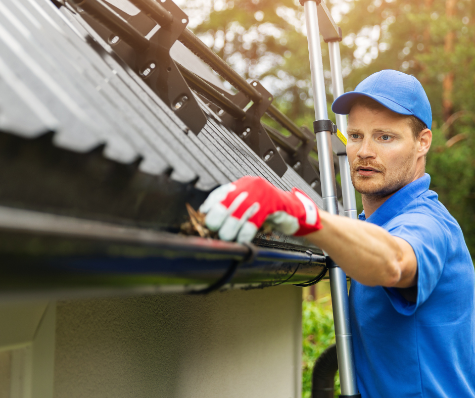 Man cleaning gutters ahead of bushfire season