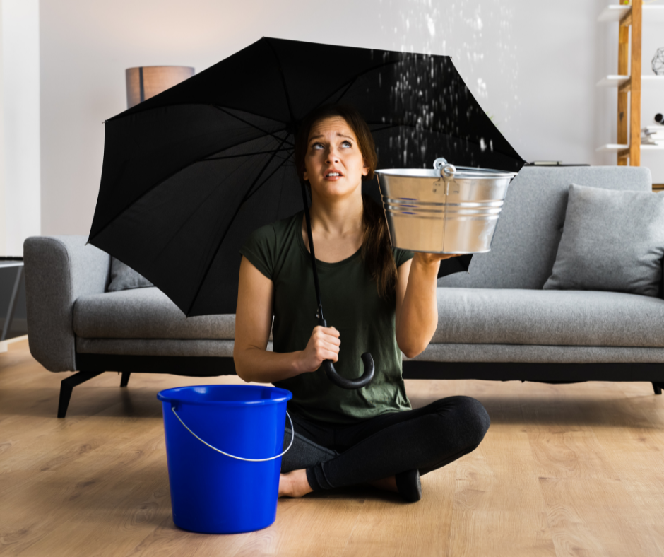 Tenant with umbrella and bucket as it rains indoors