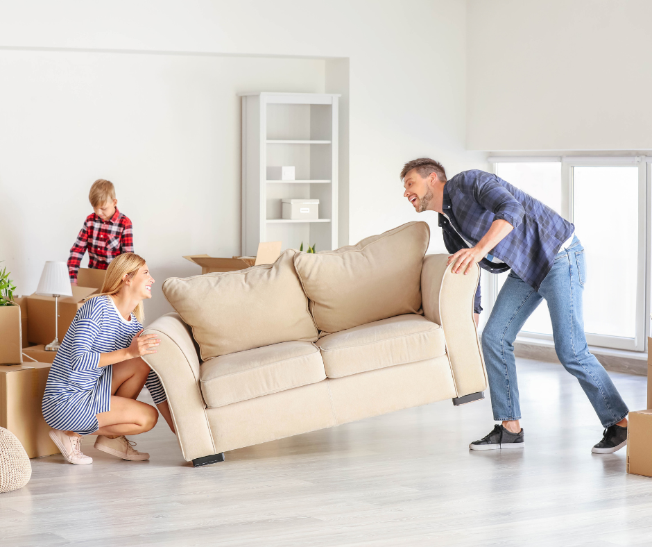 Family moving home, with couple moving the couch