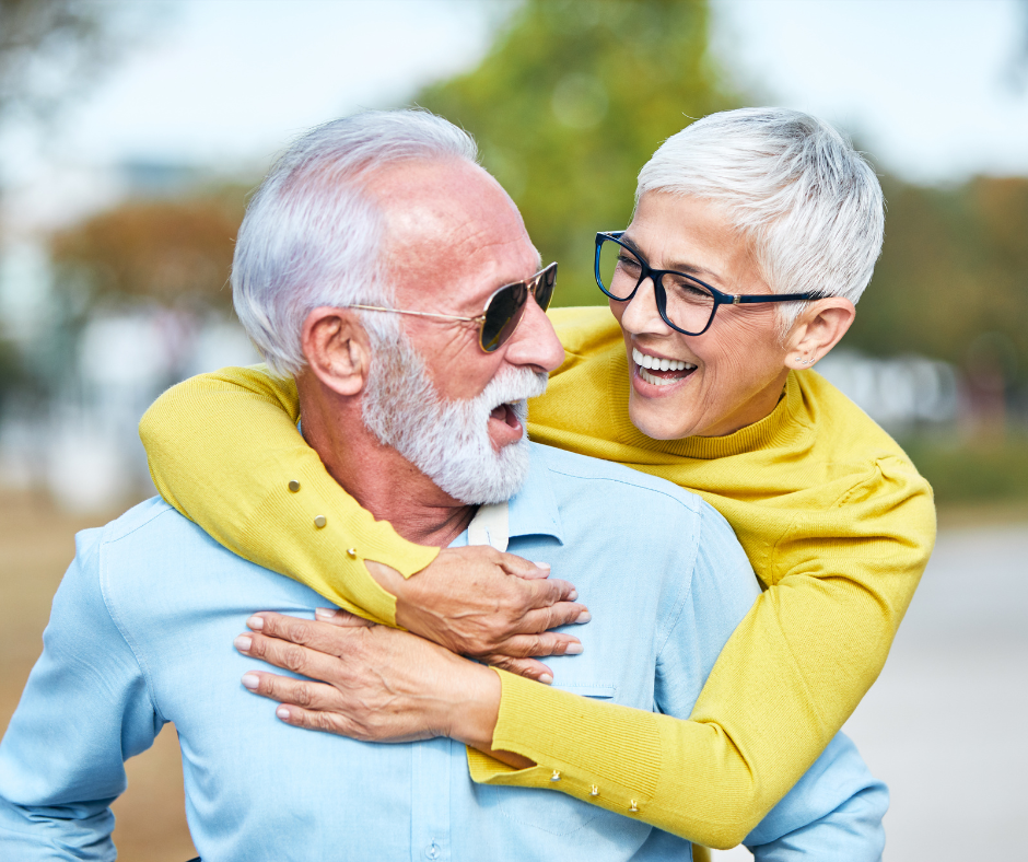 Hugging happy elderly couple downsized to a unit