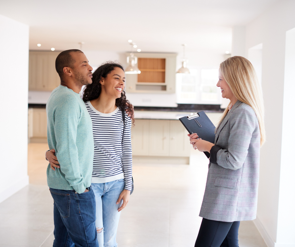 Couple viewing a house, talking to the real estate agent