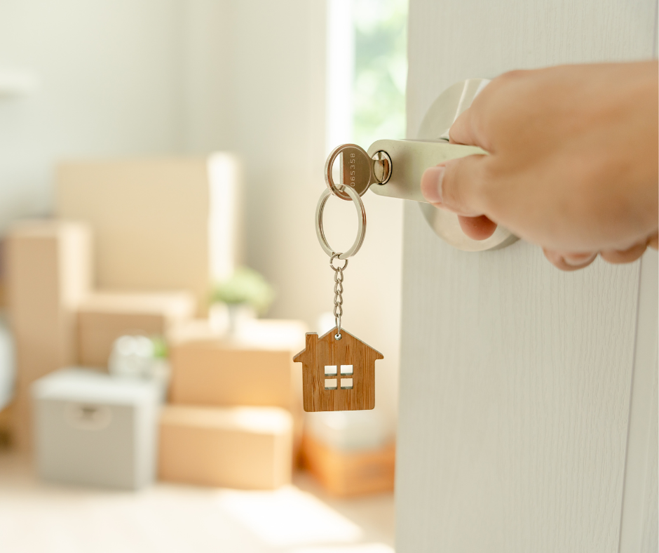 Keys dangling from door of new home on moving day