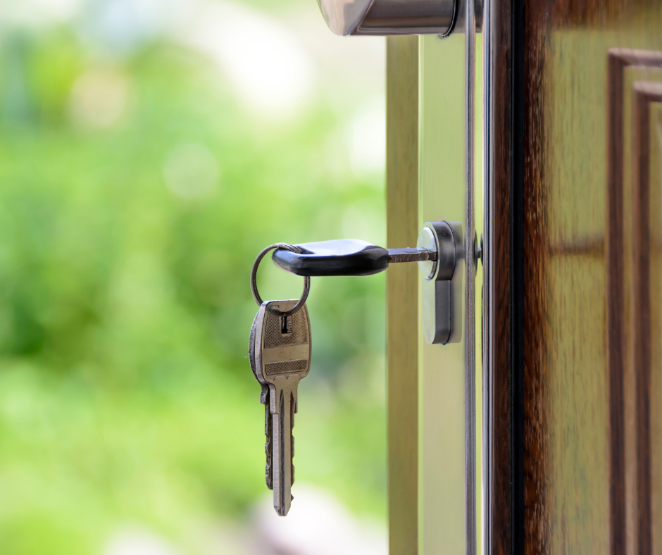 A key in an open timber door leading outside